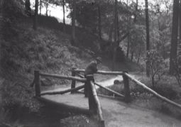 M77 Man leaning on rustic bridge, thought to be in Graves Park.